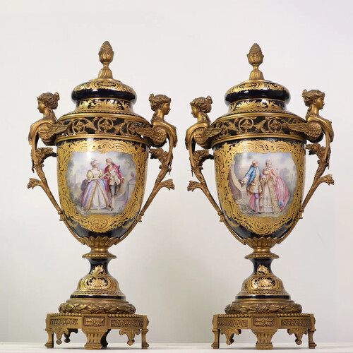 A beautiful pair of covered vases in polychrome porcelain with a royal blue ground, decorations in reserves enhanced with gold of gallant scenes and landscapes, gilt bronze mounts 