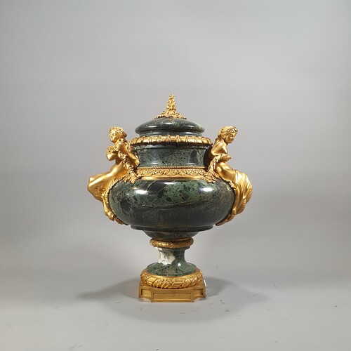 a vase covered in green tino marble adorned with a gilt bronze mount. Parisian work of the 19th century